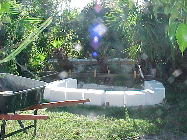 Waterfall building image #2, shows berm with forms and concrete slab for the pond base.